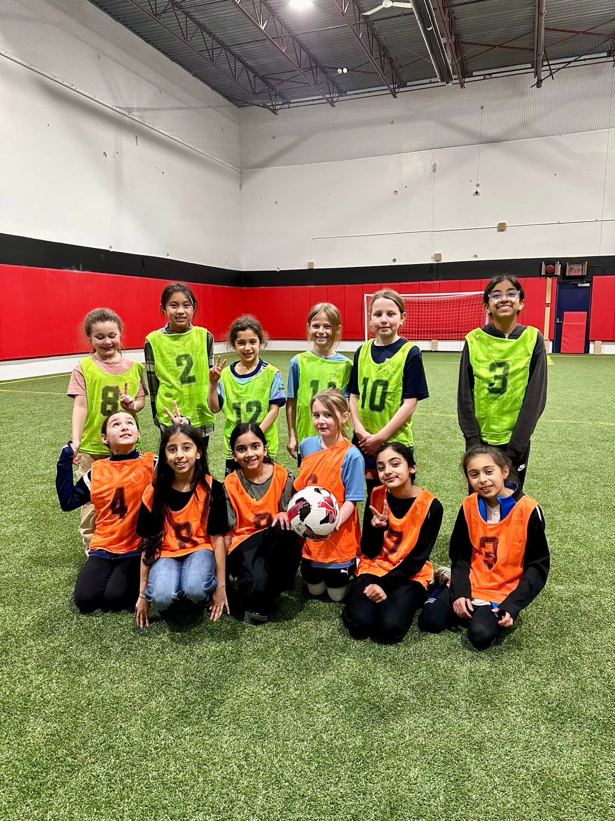 Kids on the indoor turf field at a Full 90 birthday party