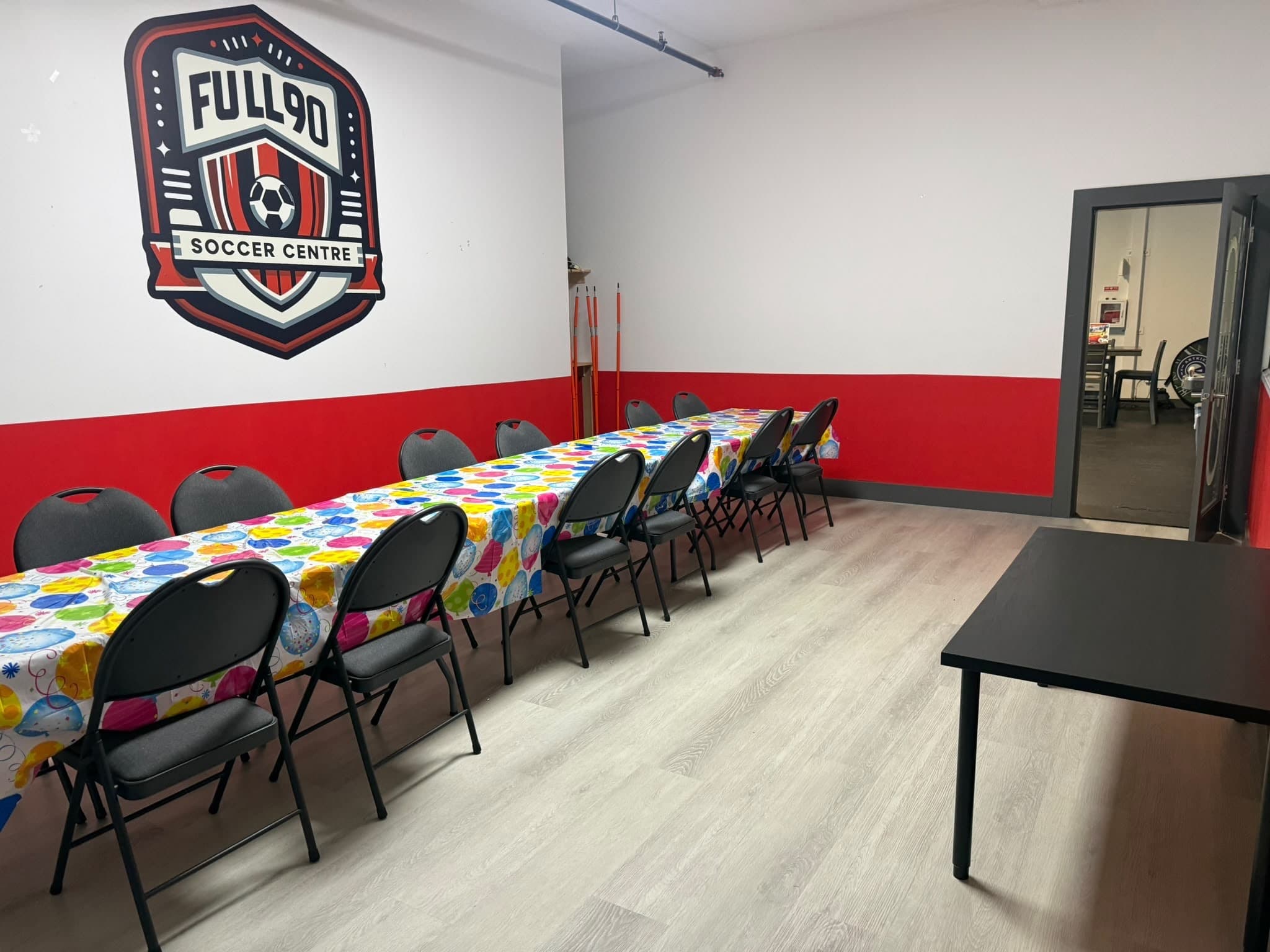 The Full 90 party room with long tables under the club crest